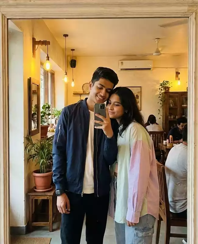 Generate a stylish Indian young couple taking a mirror selfie in a c